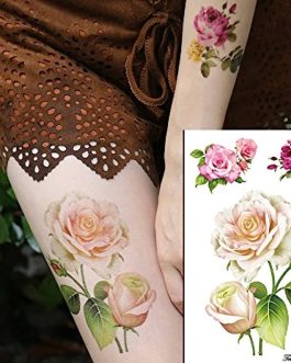 Damski tatuaż z białymi kwiatami delikatny na udo